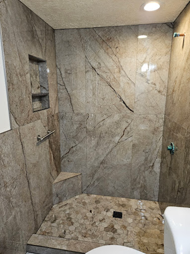 Earth tone tiling in stand up shower