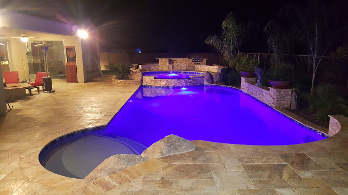 Natural stone tile pavers with custom hot tube tile in Arizona backyard