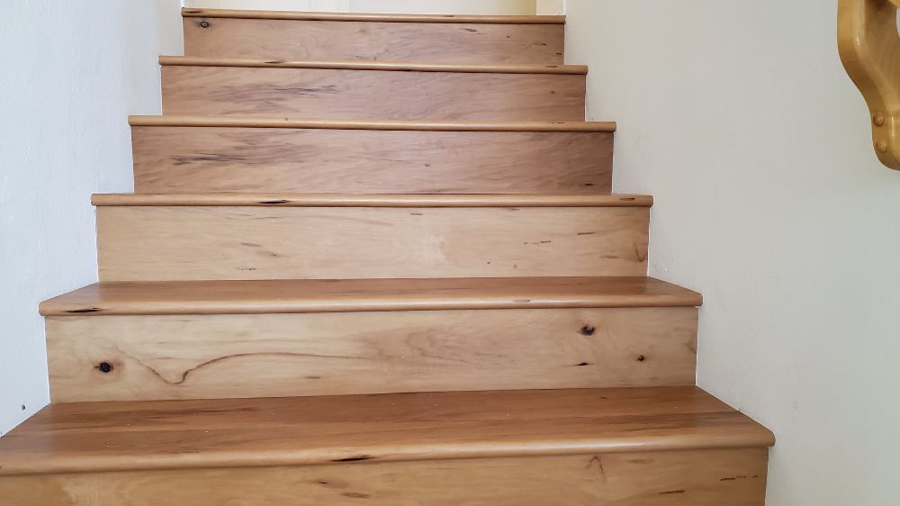 Wood flooring staircase with white walls