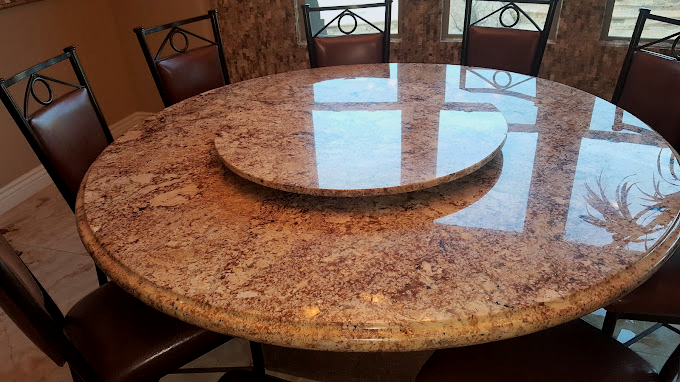 Tan and brown granite round table accent piece in dining room