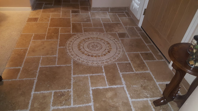 Natural stone southwestern tile with custom circular inlay by front door of residential home